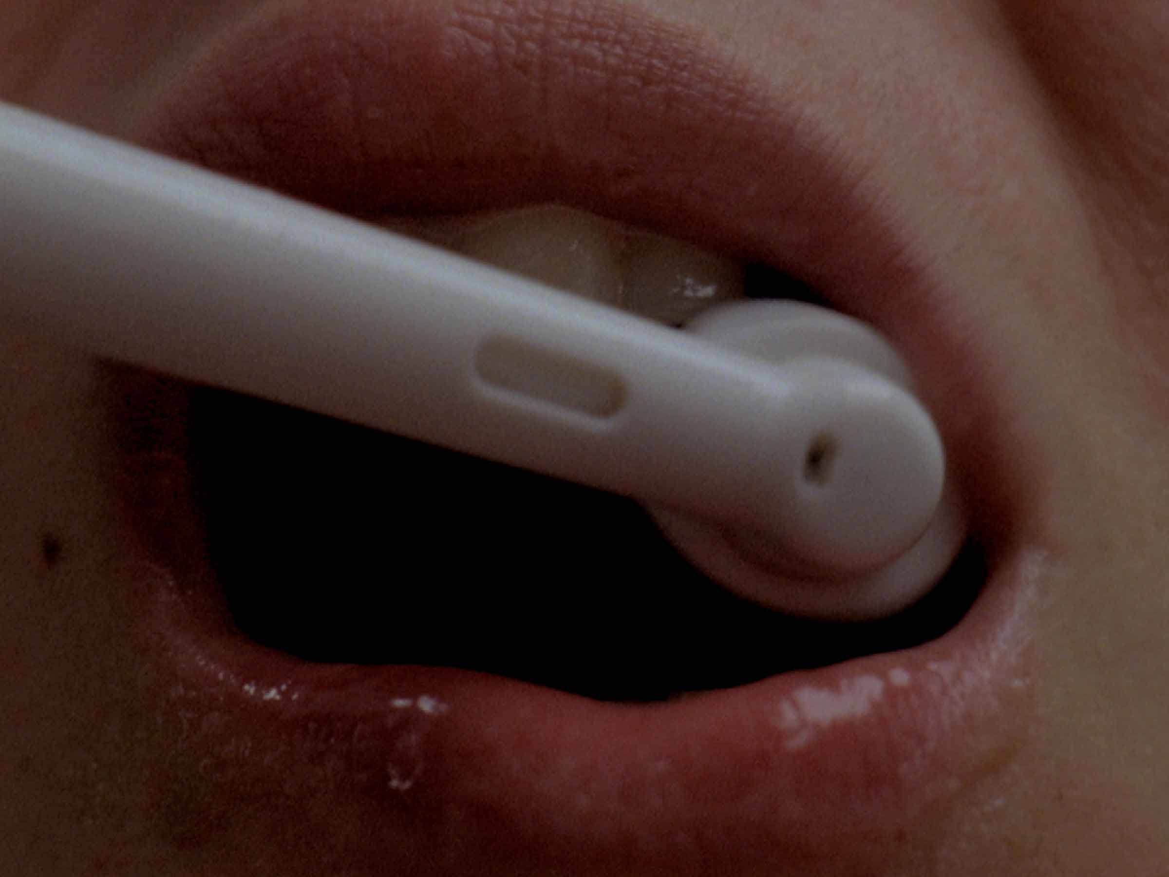 film still: woman brushing her teeth