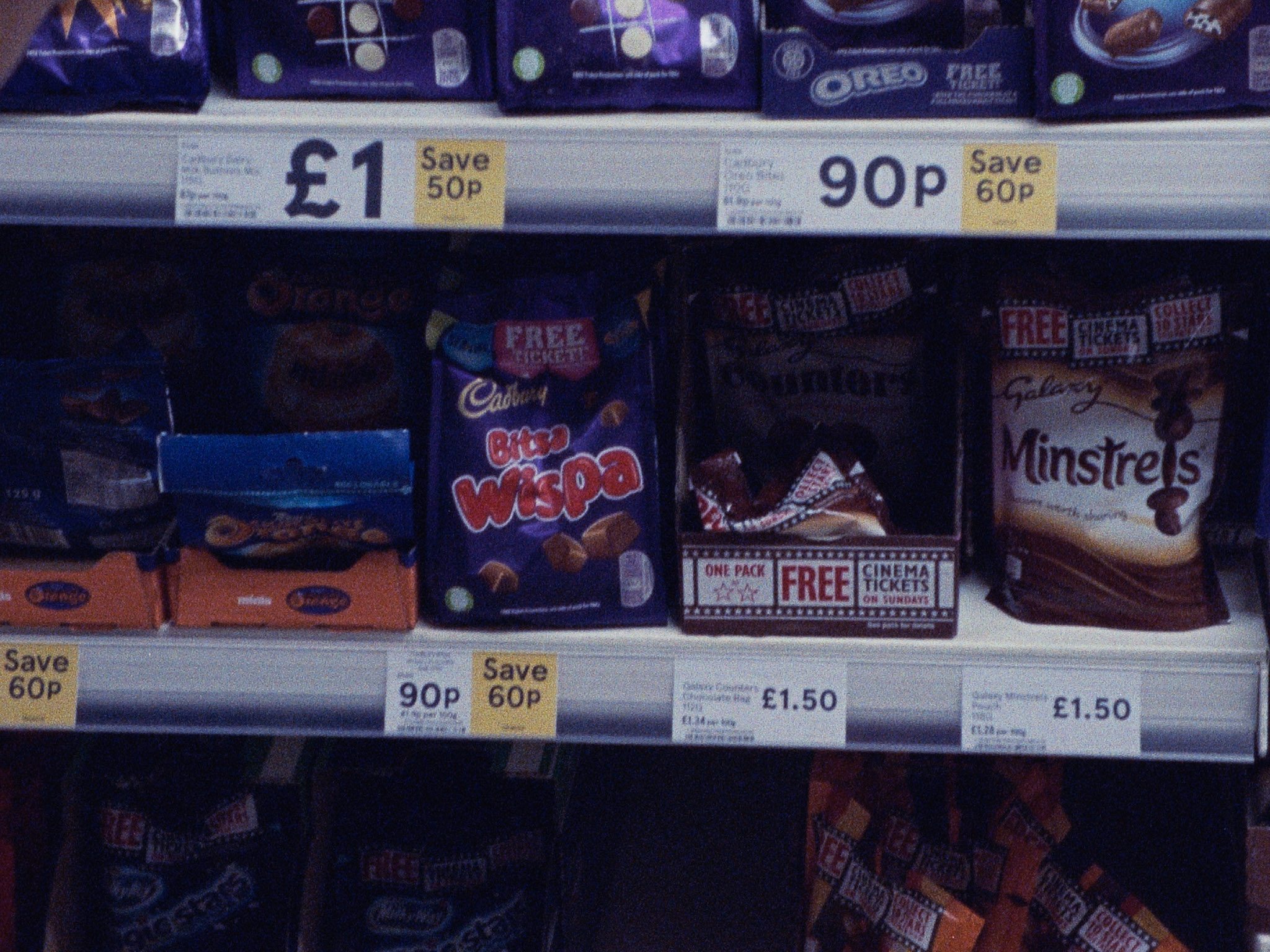16 mm film still: packs of chocolate on the shelves of a supermarket